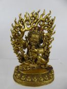 A Chinese Tibetan Gilt Bronze Figure of Mahakala, the figure takes a menacing form, set against a