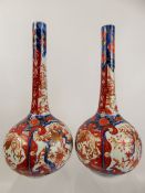 A Pair of Antique Imari Bottle Vases, typical palette, approx 36 cms, drilled for conversion.