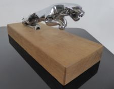 A Chrome-Plated Jaguar Bonnet Ornament, raised on a oak plinth, approx 9 x 12 x 3 cms together