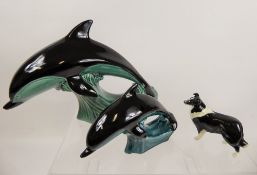 Three Pottery Figurines, including two Poole Dolphins, approx 19 x 28 cms and 11 x 17 cms,