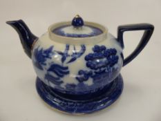 A Doulton's Blue and White Willow Pattern Tea Pot and Stand.