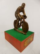 A Cycling Award to P. Mancini dated 1st March 1972, in the form of cyclist raised on a green baize