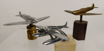 A Trio of Aerial Interest Bonnet Ornaments, including a brass plane, chrome-plated sea-plane and a