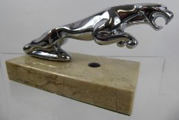 A Chrome-Plated Jaguar Bonnet Ornament, raised on a rectangular cream marble plinth, approx 12.5 x 6