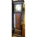 A Wurtemberg Westminster Chime Oak-Cased Grandfather Clock, the clock having a brass face with Roman