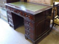 A Twin Pedestal Desk, tooled green leather top, centre drawer with four drawers either side,