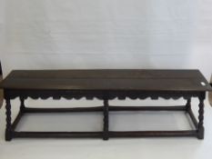 An Antique Oak Coffin Bench, raised on six barley twist legs with stretchers, approx 153 x 47 x 32