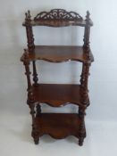 An Antique Rosewood Wot Not (circa 1880), four graduated 'serpentine' shelves, with turned legs