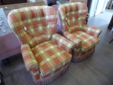 Two Contemporary spring -back armchairs, in tartan upholstery.