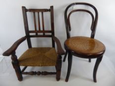 A Child's Bent Wood Chair, together with a child's elbow chair with rush seat and turned stretchers.