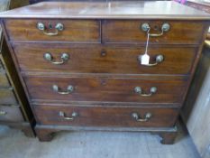 An Oak Chest of Drawers, with brass drop handles, two short and three long drawers on bracket