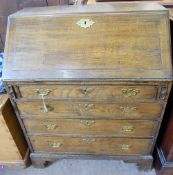 An Oak Georgian Bureau, (possibly a lady's bureau), with four graduated drawers and brass drop