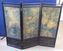 An Ebonised Three Leaf Screen, depicting water birds and reeds, each leaf with galleried top and