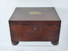 A Regency Mahogany Sewing Box on Bun Feet. The box having a secret drawer with contents.