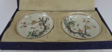 Two Chinese Porcelain Plates, hand painted with prunus blossom, character marks to base, in a fitted