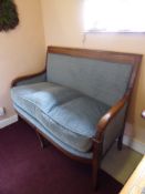 An Antique Regency Style Mahogany Framed Sofa, having blue upholstery with reeded elbow rests,