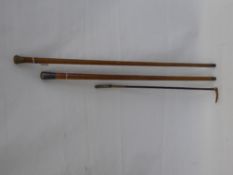 A Child's Silver Banded Riding Cane, together with a silver top cane and one other. (3)