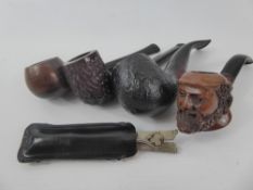 An Antique Carved Briar Smoking pipe in the form of a bearded man's head together with three other