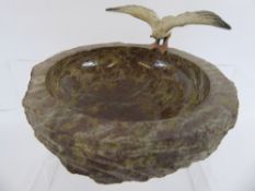 A Marble Pin Dish, with a seagull perched on the rim.