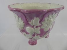 A Small Minton Pink-Glazed Planter with four feet and decorated with white moulded flowers,