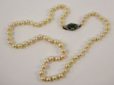 A Set Of Lady's Graduated Pearls, on green and white stone clasp, 5mm to 9 mm, the length approx