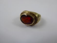 A 9 ct Yellow Gold Bark Finish Red Stone Ring, mm CJ size L, approx 8 gms.