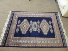 A Persian Woollen Rug, cobalt blue ground with turquoise, white and peach geometric design,