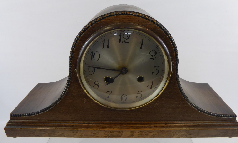 An Edwardian German Oak-Cased Napoleon Mantle Clock, with beaded edge design and a silvered face,