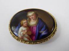 An Antique Hand Painted Porcelain Brooch, the brooch depicting mother and child approx 50 mm.