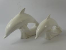 Two White Poole Pottery Dolphins, one approx 18 x 26 and one smaller, approx 15 x 22 cms.