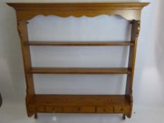 A Light Oak Plate Rack, having two shelves with four small and one large spice drawer beneath,