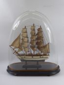 A Hand-Made Wooden Clipper Ship with full rig on a wooden plinth and covered by a glass dome, approx