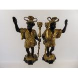 A Pair of Gilt Brass Blackamore Candlesticks, each with feathered headdress, approx 30 cms.