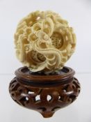 A Circa 1900 Chinese Ivory Puzzle Ball, carved with chasing dragon, approx 22 cms d.