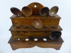 A Welsh Mid 19th Century Elm Cawl Spoon Rack, the rack being three tiered together with six cawl