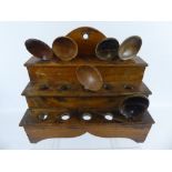 A Welsh Mid 19th Century Elm Cawl Spoon Rack, the rack being three tiered together with six cawl