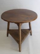 An Antique Oak Cricket Table, with circular plank top on three legs united by moulded stretchers,