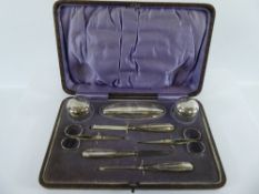 A George V Silver Manicure Set, comprising of manicure tools, two scissors, buffer and two cut glass