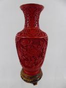 A Chinese Carved Cinnabar-Coloured Lacquer Baluster Vase (1950 - 1980), overlaid on blue enamel,