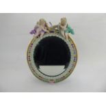 A Meissen Figural Dressing Table Easel Mirror, hand painted with floral decoration, the top of the