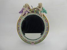 A Meissen Figural Dressing Table Easel Mirror, hand painted with floral decoration, the top of the