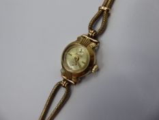 A Lady's 9ct Gold Acurist Wrist Watch, having baton numerals, on a 9ct gold bracelet (clasp