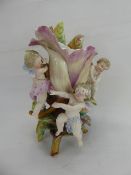 A KPM Porcelain Vase, with three putti in relief playing 'Blindmans Bluff' at the base of a