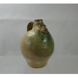 A Small Glazed Jug depicting a smiling face to the front, approx 16 cms.