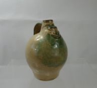 A Small Glazed Jug depicting a smiling face to the front, approx 16 cms.