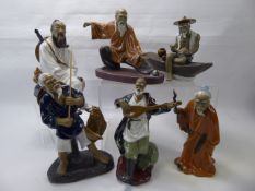 A Quantity of Japanese Shi Wan Figurines, depicted in various poses, including Tai Chi, Fishing,
