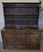 An 18th Century Oak Dresser with brass hinges and swan neck handles, upper plate rack with pierced