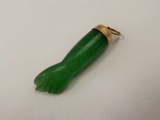 A Chinese Yellow Metal and Apple Green Jade Pendant in the form of a clenched fist, approx 36 mm and