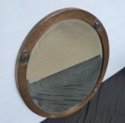 An Arts and Crafts Oval Hammered Copper Framed Mirror, approx 83 x 58 cms.