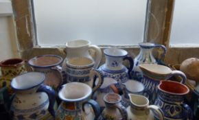 Twelve Portuguese Ceramic Jugs, of various sizes and styles, hand-painted in typical fashion.